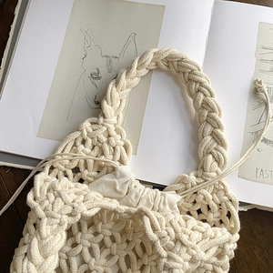 Handmade woven handbag in cream white with braided handles and drawstring inner bag