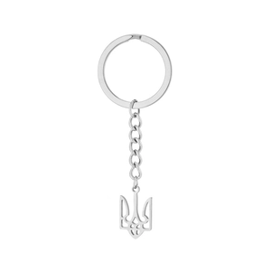 Macro shot of silver titanium steel keychain featuring the Ukrainian national crest trident