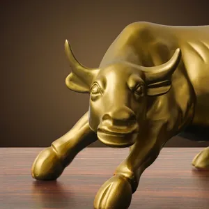 Golden resin bull statue in dynamic charging pose for office and home decor
