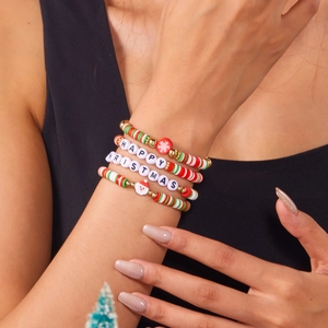 Detail of Christmas beaded bracelet set featuring Santa charms and festive letter beads