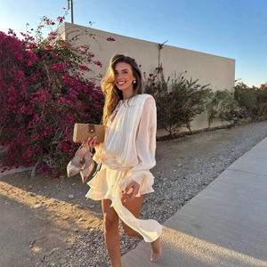 Elegant white ruffled chiffon mini dress with asymmetric hem for beach resort look