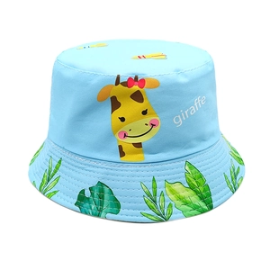 Close-up of kids bucket hat with giraffe print and tropical leaves on blue cotton fabric