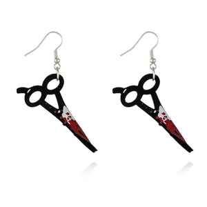 Close-up of Halloween scissors acrylic earrings with realistic red blood splatter effect