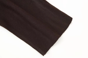 Close-up of dark coffee knit fabric texture showing premium stitch quality on dress