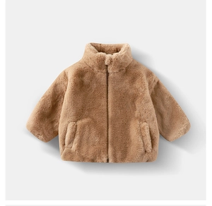Macro shot of faux rabbit fur kid jacket with stand collar and hidden zip in camel