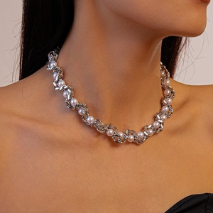 Silver cuban chain and white pearl necklace on model neck for elegant look