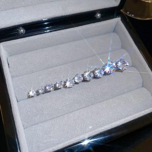 Macro detail of gradient cubic zirconia studs on a silver base in a velvet box