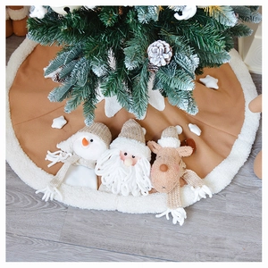Detail of knitted Christmas tree skirt with 3D plush Santa, reindeer and snowman figures