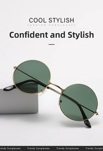 Detail of vintage round sunglasses with gold metal frame and dark green ocean lenses