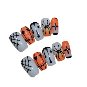 Handmade Halloween press-on nails with orange and black hand-painted spider web designs