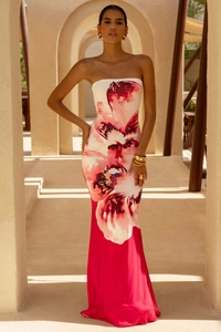Detail of elegant tube top maxi dress with bold magenta floral print on white fabric