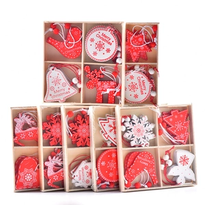 Set of wooden Christmas tree ornaments with red and white reindeer in a wooden box