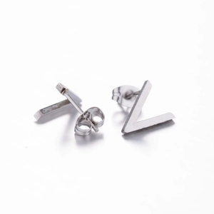Close-up of minimalist silver stainless steel V-shaped and bar geometric stud earrings