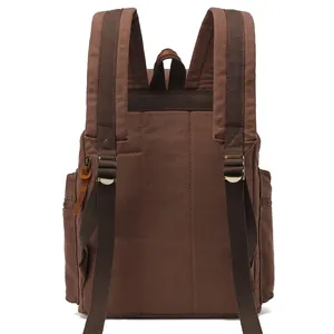 Vintage brown canvas backpack with padded straps and metal buckles shown from the back