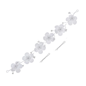 Detail of white fabric flowers and pearls on a bridal headband with black hair clips