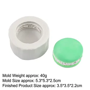 Macro detail of white silicone macaron mold with mint green finished dessert sample