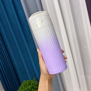 Detail of gradient purple stainless steel coffee cup with textured vertical ridges