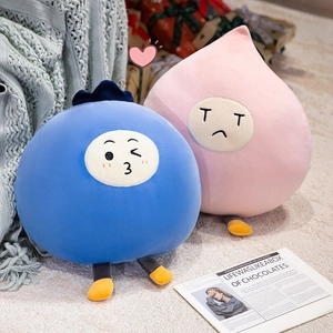 Cute cartoon plush pillows in blue and pink colors on a cozy home background