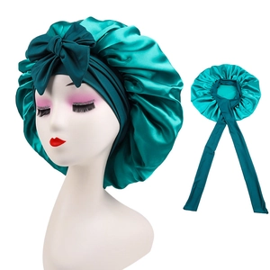 Teal satin sleep bonnet with large decorative bow and adjustable long ribbons
