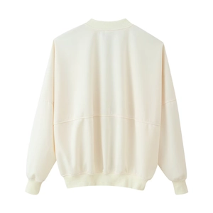 Detail view of the back of a cream bomber jacket showing ribbed cuffs and horizontal seam line