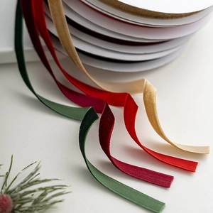 Luxe velvet Christmas ribbons in red, green, and beige for festive gift wrapping and DIY crafts