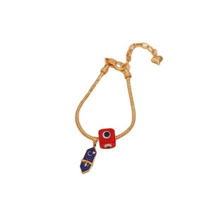 Gold snake chain bracelet with red devil eye bead and blue honeybee enamel charms