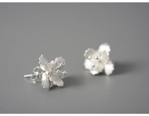 Detailed close-up of 925 sterling silver begonia flower stud earrings with matte finish