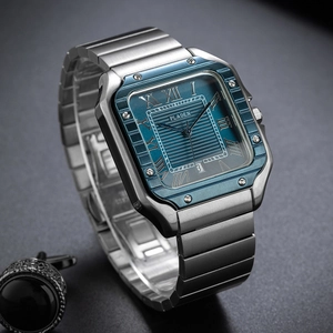 Close-up of square silver watch with blue textured dial and Roman numeral markers