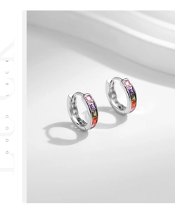 Macro shot of silver mini hoop earrings set with colorful square-cut zircon stones