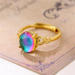 Adjustable gold ring with large oval rainbow gemstone and heart-shaped hollow design