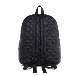 Rear view of black quilted rhombus backpack featuring adjustable straps and top handle