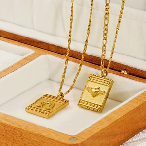 Gold angel wing heart and rainbow engraved rectangular pendant necklaces in jewelry box
