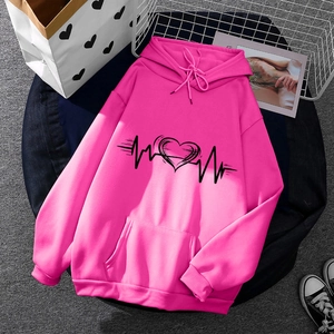 Rose pink hooded sweatshirt with heart print on flat lay with accessories