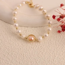 Detail of freshwater pearl bracelet with pink centerpiece and gold adjustable clasp