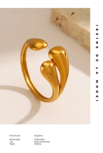 Macro view of adjustable gold teardrop ring with polished finish on a stone