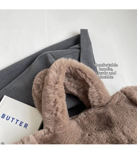Detail of soft faux fur tote bag handle with plush brown texture on minimalist background