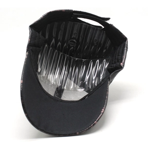 Detail view of adjustable black baseball cap featuring faux crocodile leather texture