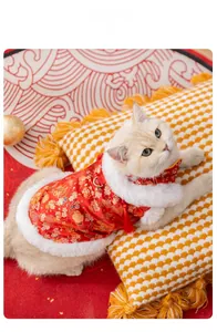 Detail of red festive cat Tang suit with floral embroidery and white faux fur trim