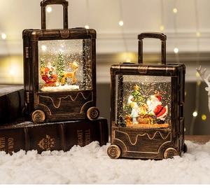 Detail of vintage copper Christmas suitcase lanterns with sparkling snow and Santa scenes