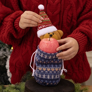 Knitted Christmas gift bag with drawstring featuring teddy bear and apple accessory