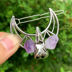 Gothic hollow moon hair clip featuring a raven skull design and purple crystal accents