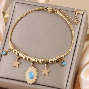 Detail view of gold titanium steel bracelet with star charms and blue turquoise stones