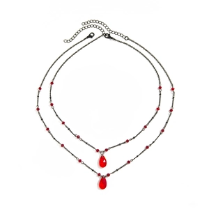 Detailed macro shot of gothic layered black chain with red water drop crystal pendants