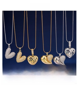 Detailed view of copper gold heart pendants with shimmering zircon stones on necklaces