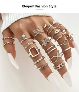 Detailed close-up of Bohemian silver ring set with butterfly, pearl and floral designs