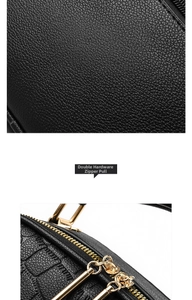 Close-up of black textured leather handbag featuring premium gold dual metal zippers