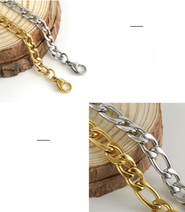 Detailed macro view of gold and silver stainless steel Figaro chains with lobster clasp