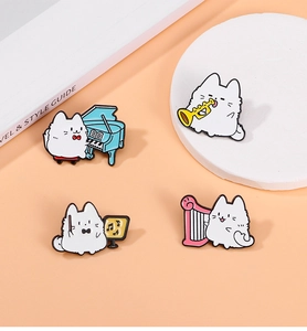 Detailed view of four cute enamel cat pins playing musical instruments on pink background