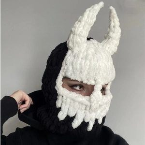 Detail of knit balaclava with devil horns featuring black and white contrast stitching