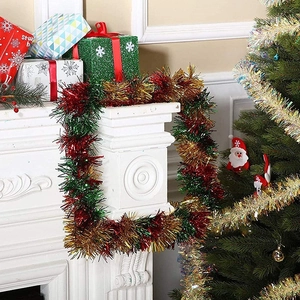 Mix color Christmas tinsel garland hanging on fireplace for festive home decoration